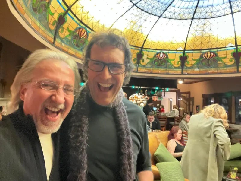 Two guests laughing beneath the dome