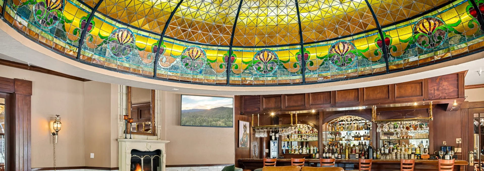 The gold, green and blue stained glass of the Tiffany Dome